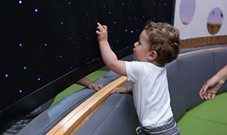 A young customer interacts with Fibre Optic wall.