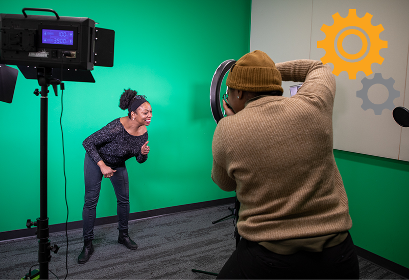 a person filming a dancer in front of a green screen
