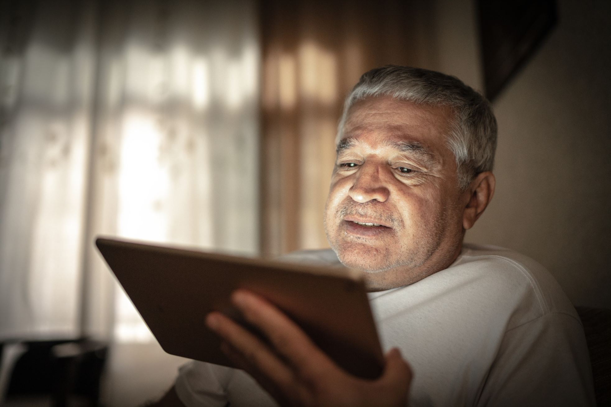 Senior using a tablet device