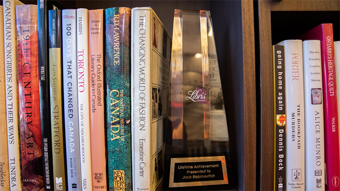 Libris Lifetime Achievement award Presented to Jack Rabinovitch on a shelf surrounded by books from Jack’s collection.